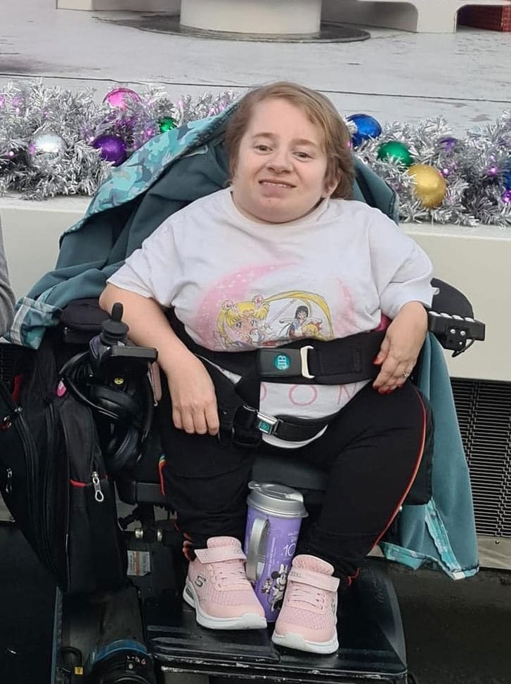 Amelia, a woman with a physical disability, smiling during her trip.